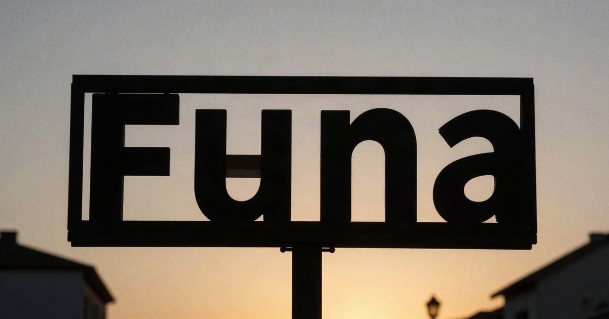 Illustrative image: silhouette of a job offer sign backlit at sunset